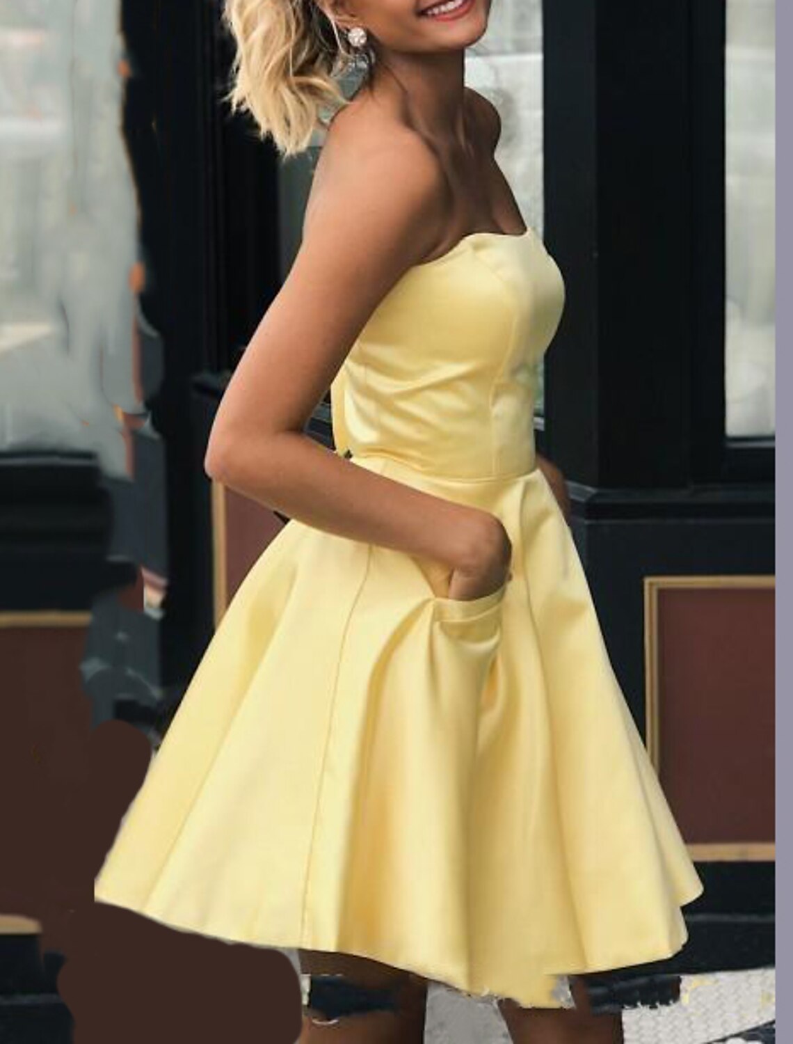 Side profile of the stylish A-line strapless short mini cocktail dress.