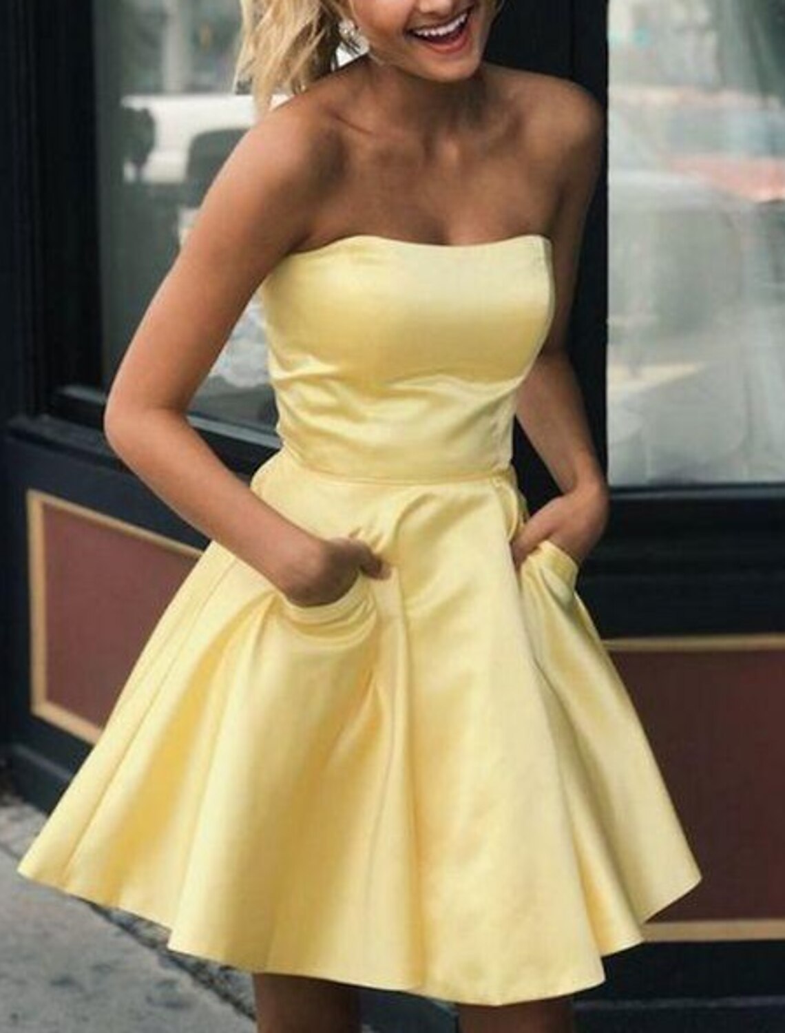 Full length view of the versatile A-line strapless pleated satin dress.