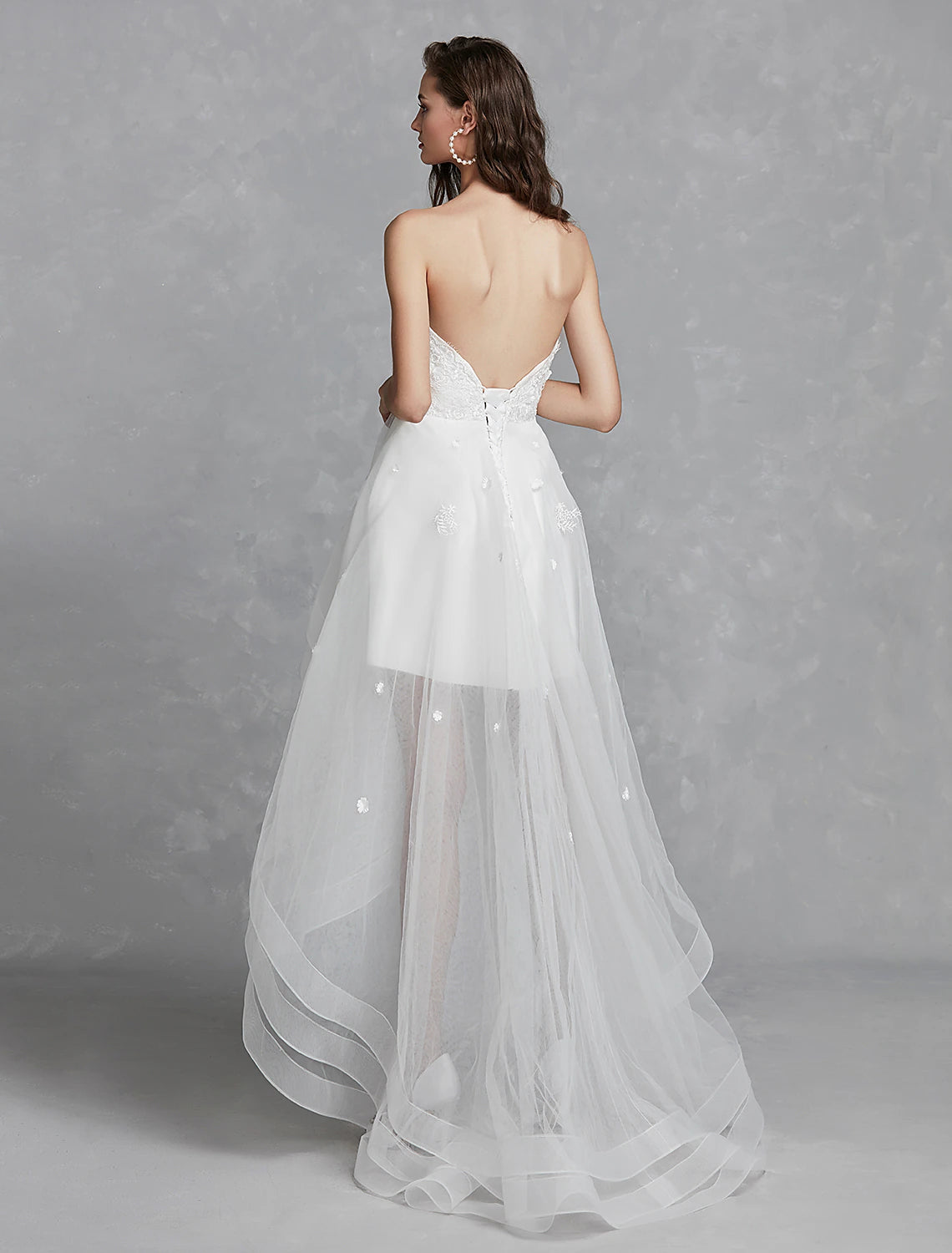 Back view of A-Line sweetheart strapless white reception bridal gown with lace appliques.