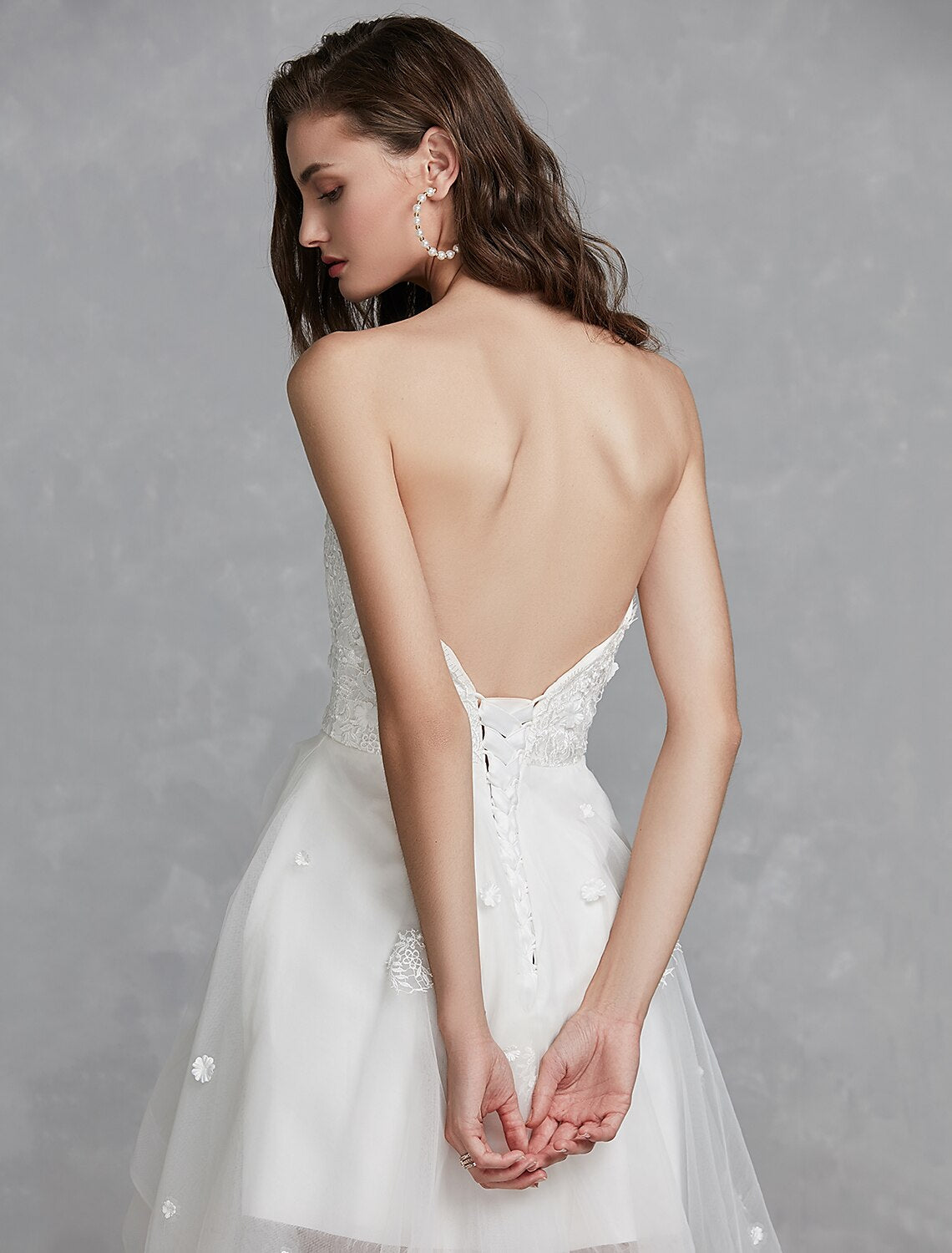 Close-up of lace appliques on white A-Line sweetheart bridal gown.