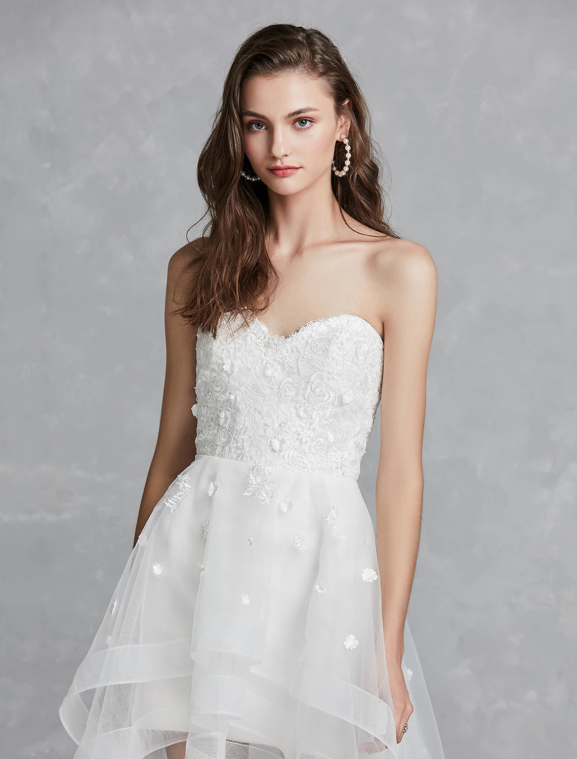 Full length view of A-Line sweetheart white reception dress with asymmetrical hem.