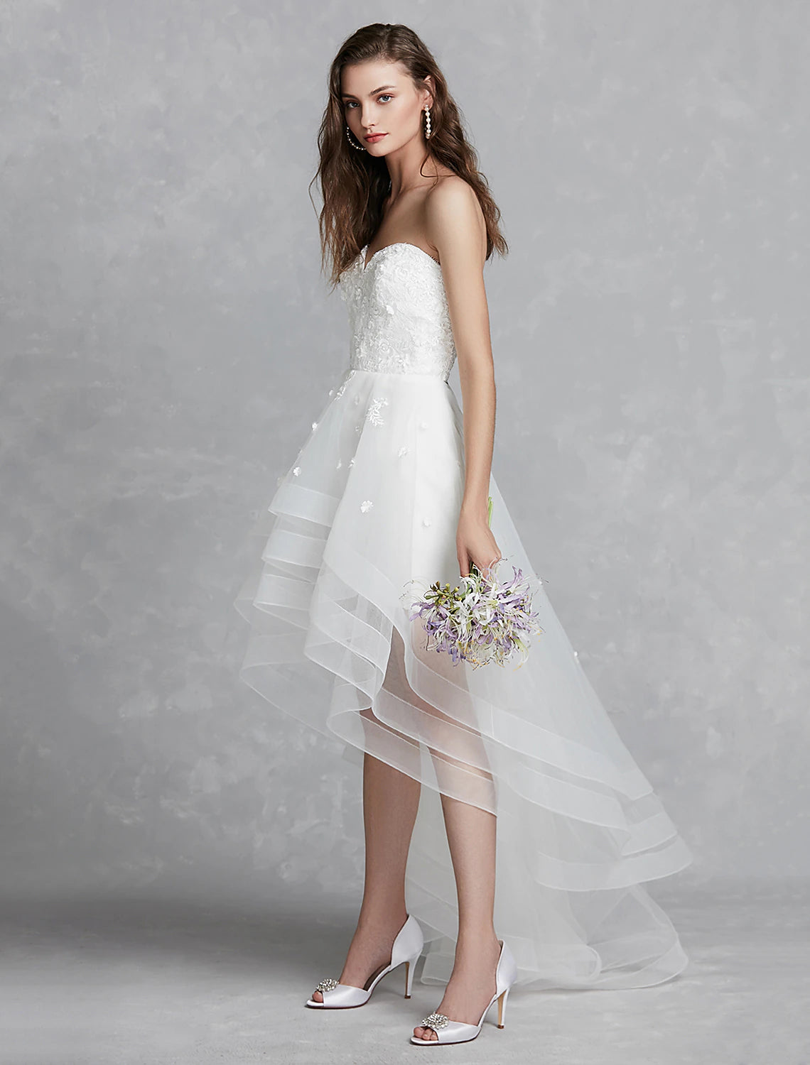 Model wearing A-Line sweetheart strapless white reception bridal gown.