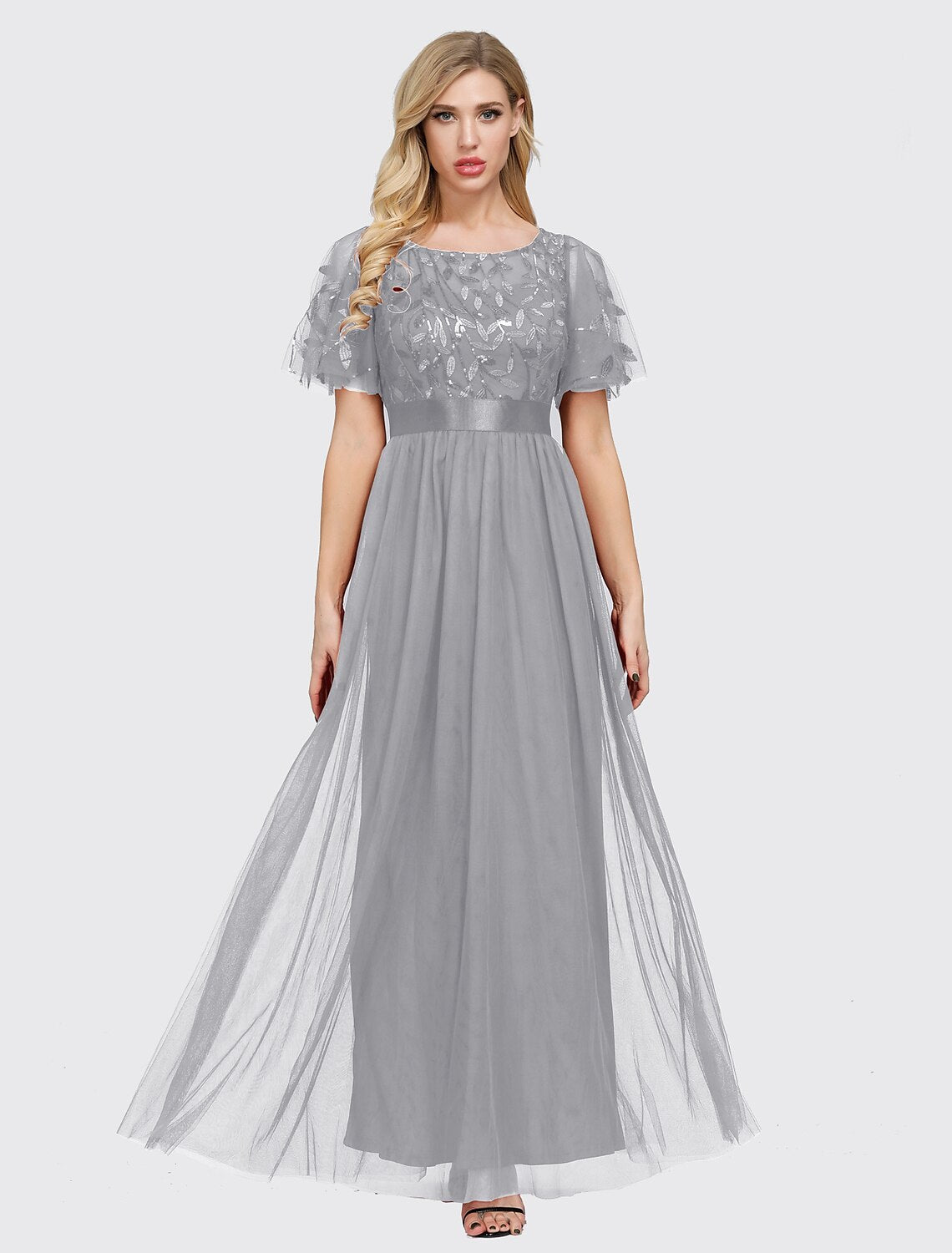 Model posing gracefully in the elegant tulle prom gown.