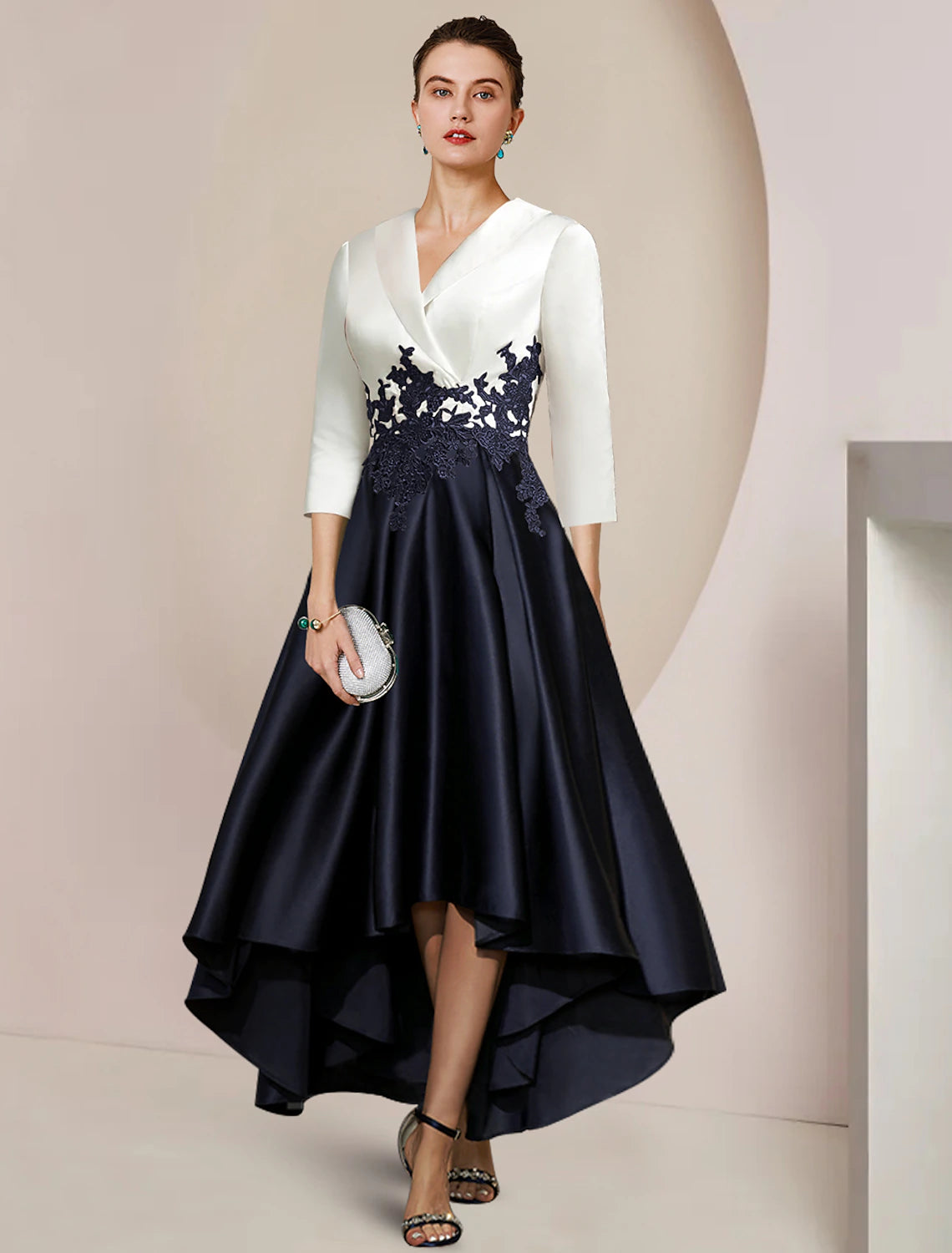 Elegant A-Line high-low tea length dress with lace appliques and 3/4 sleeves.