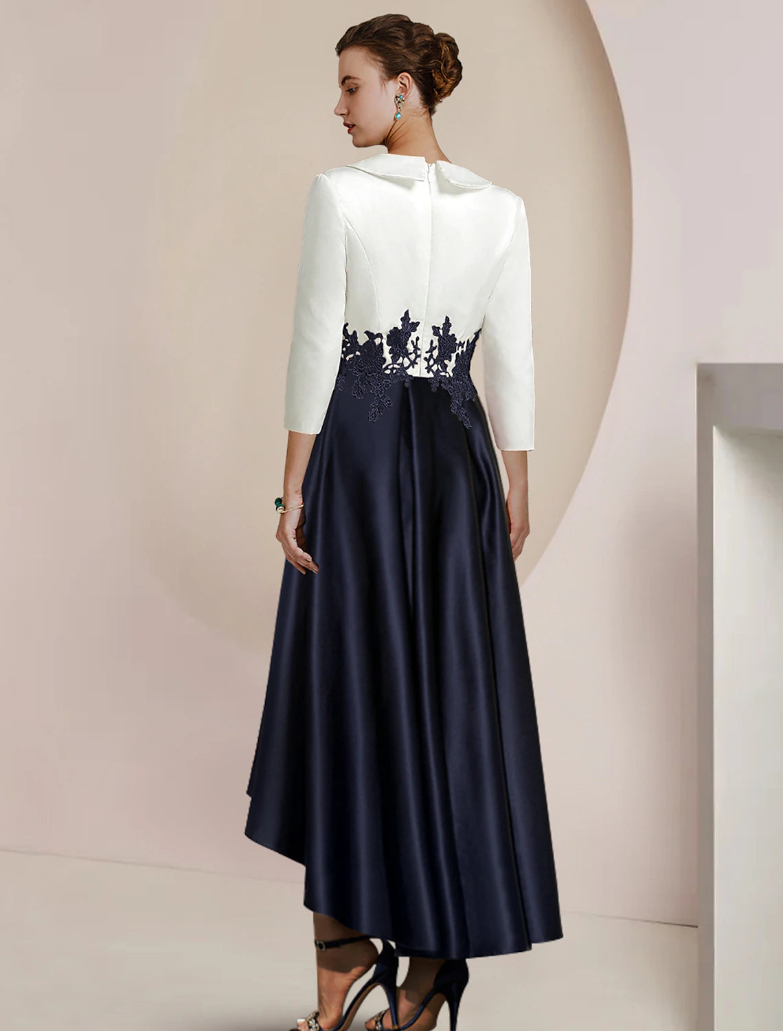 Elegant A-Line high-low tea length dress with lace appliques and 3/4 sleeves.