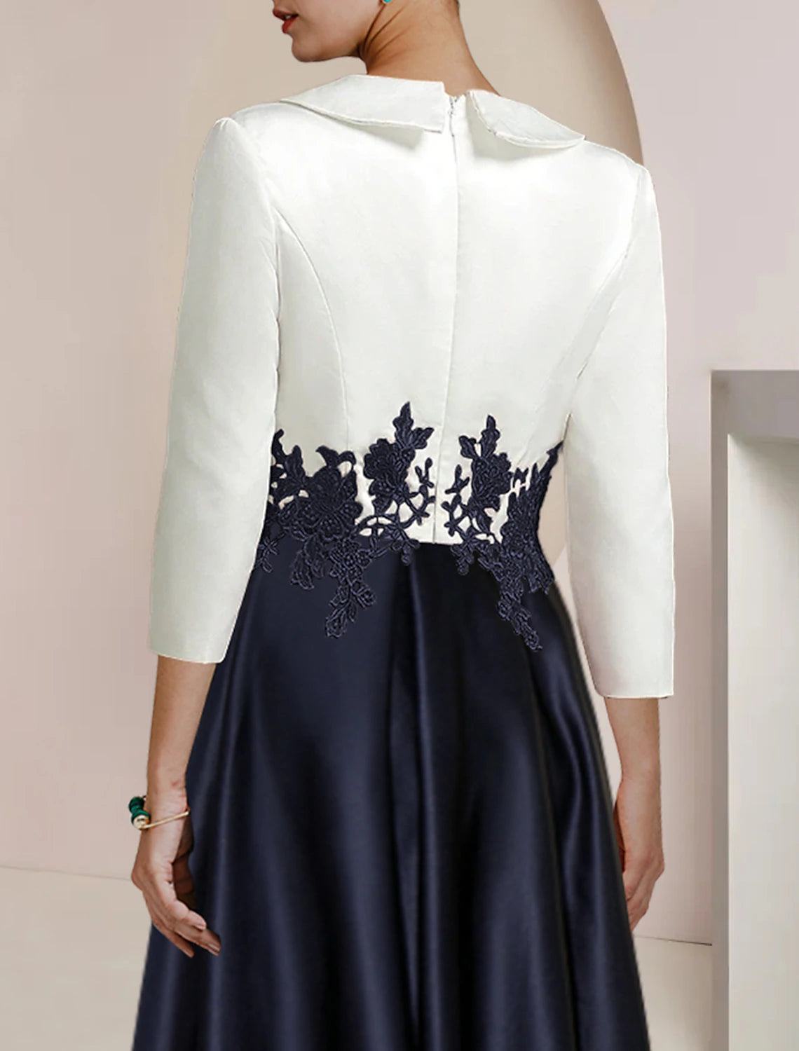 Elegant A-Line high-low tea length dress with lace appliques and 3/4 sleeves.