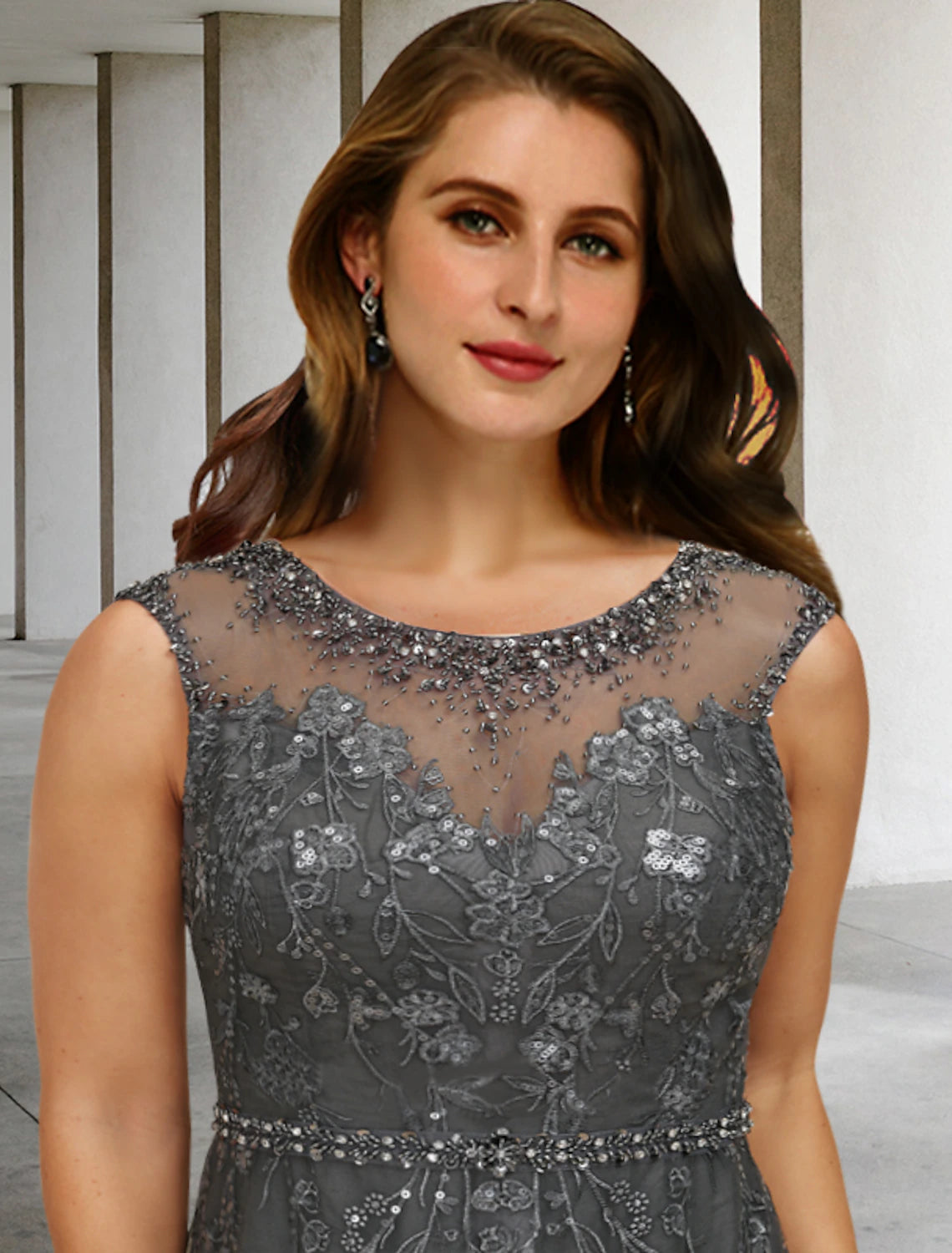 Close-up of the jewel neck and lace beading on an elegant formal dress.