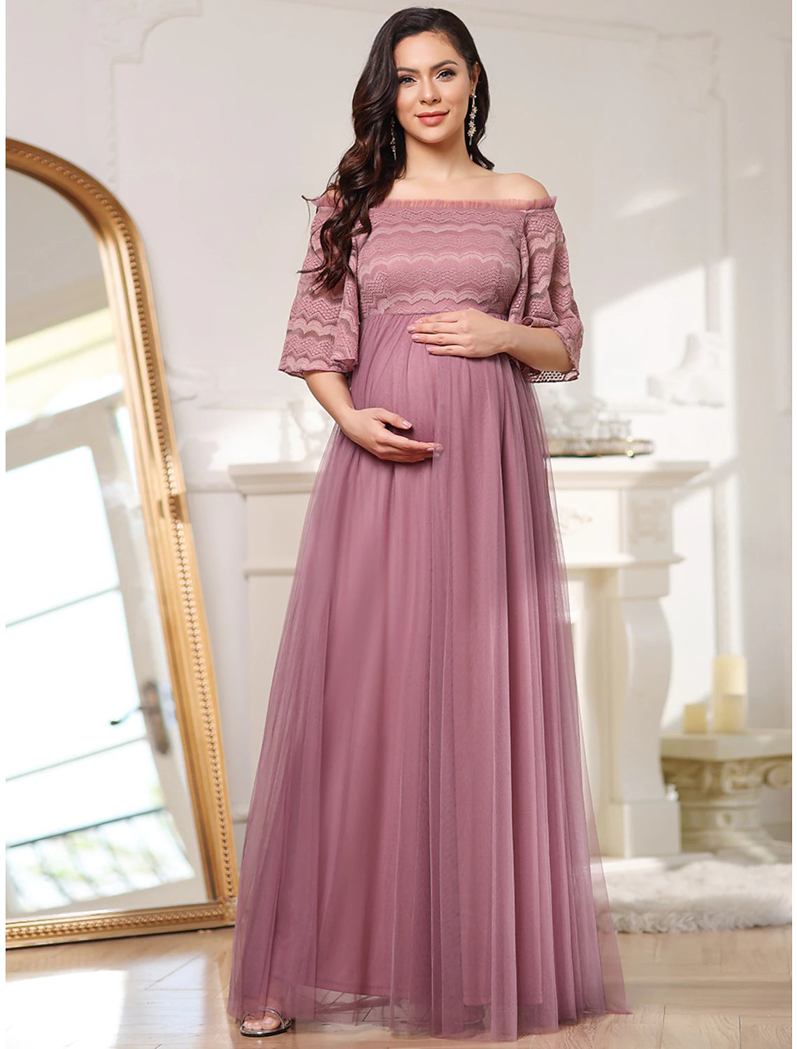 Model wearing a floor-length A-line off-shoulder gown with tiered lace tulle.
