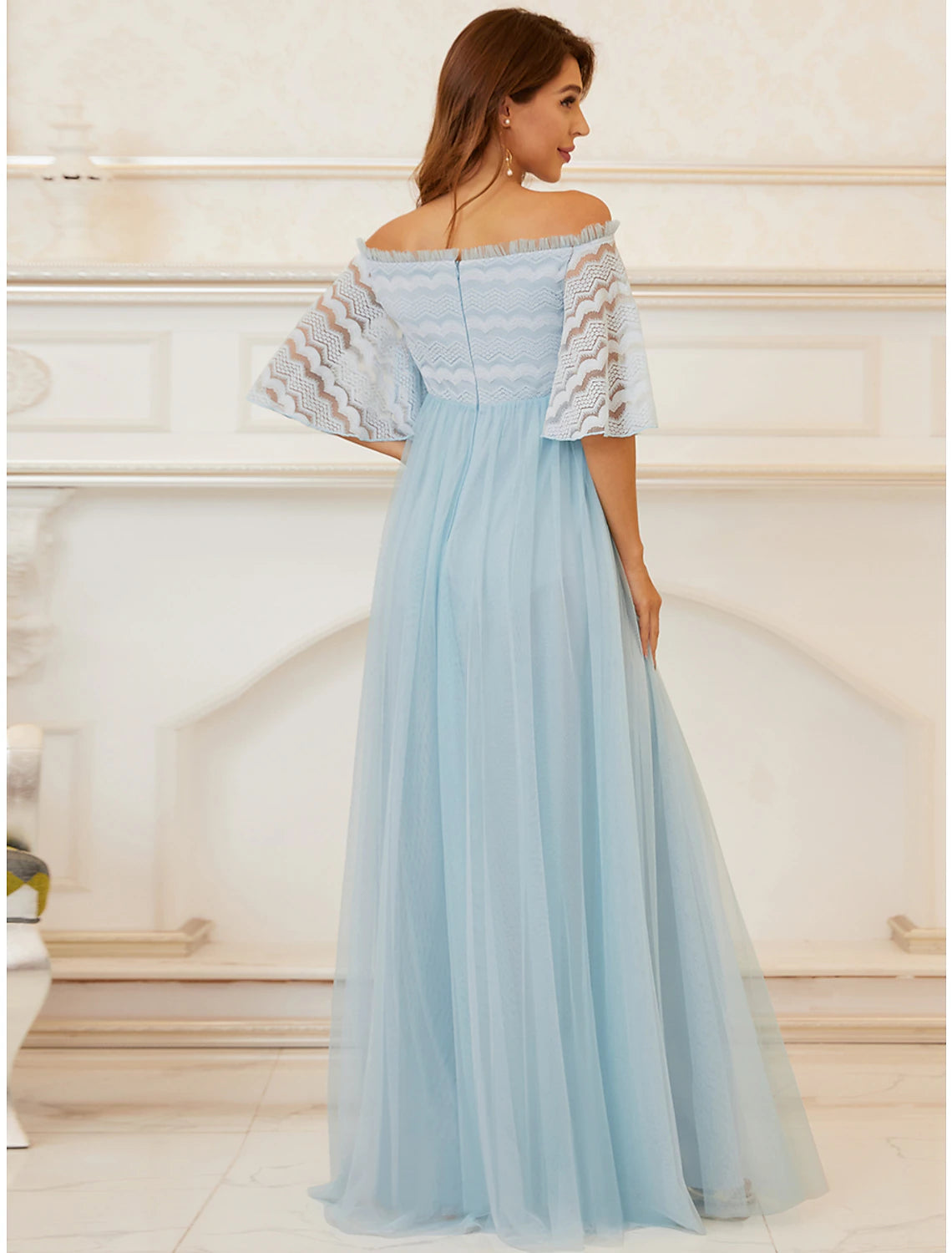 Detail of the tiered lace tulle skirt on the elegant floor-length gown.