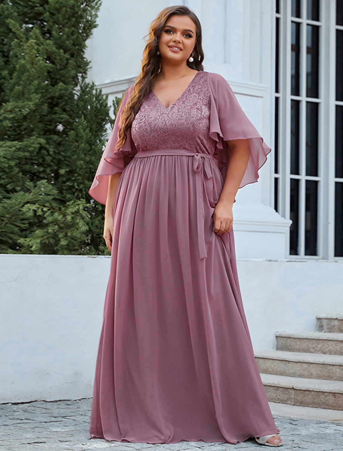 Side profile of an elegant A-line V-neck half sleeve chiffon plus size Mother of the Bride dress.
