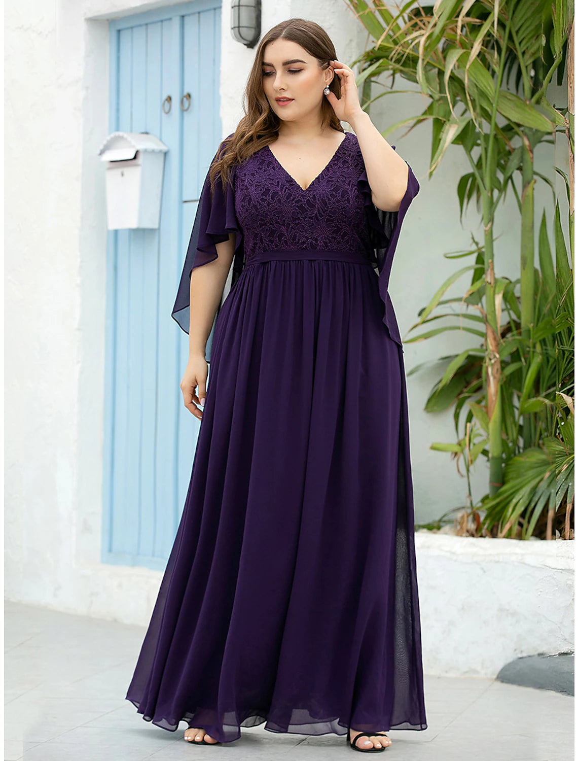 Elegant A-line V-neck half sleeve chiffon plus size Mother of the Bride dress in a graceful pose.