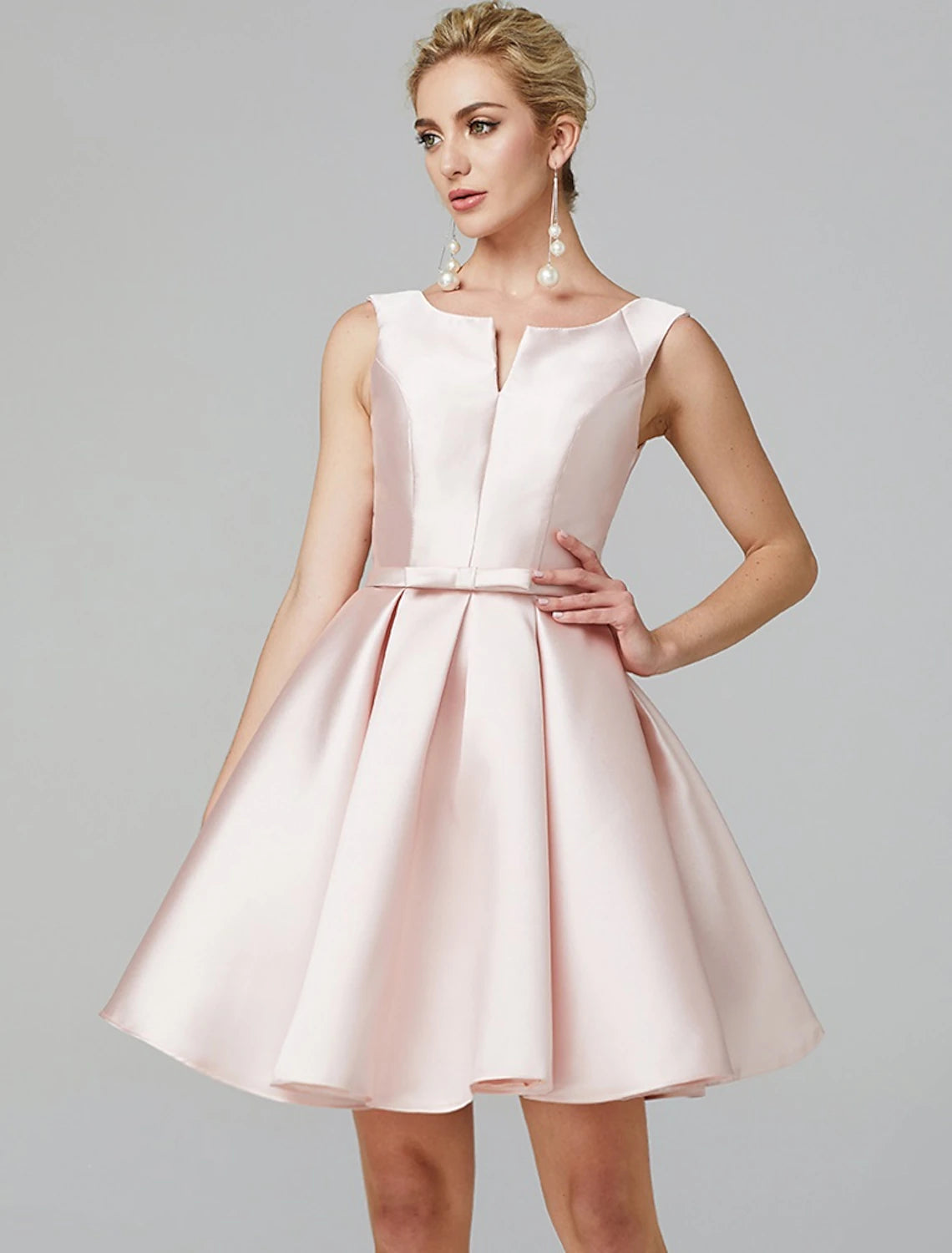 Back view of the satin dress, showing bows and pleats.
