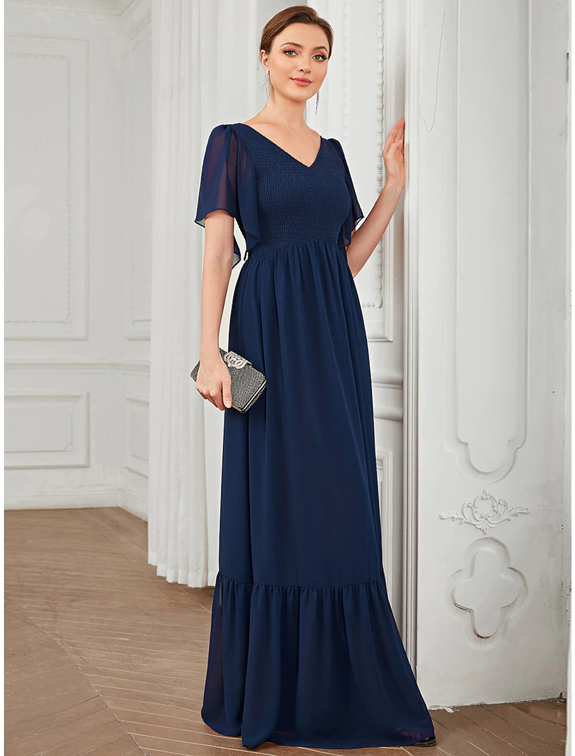 Elegant model in a dark blue A-Line V-Neck short sleeve chiffon prom dress.