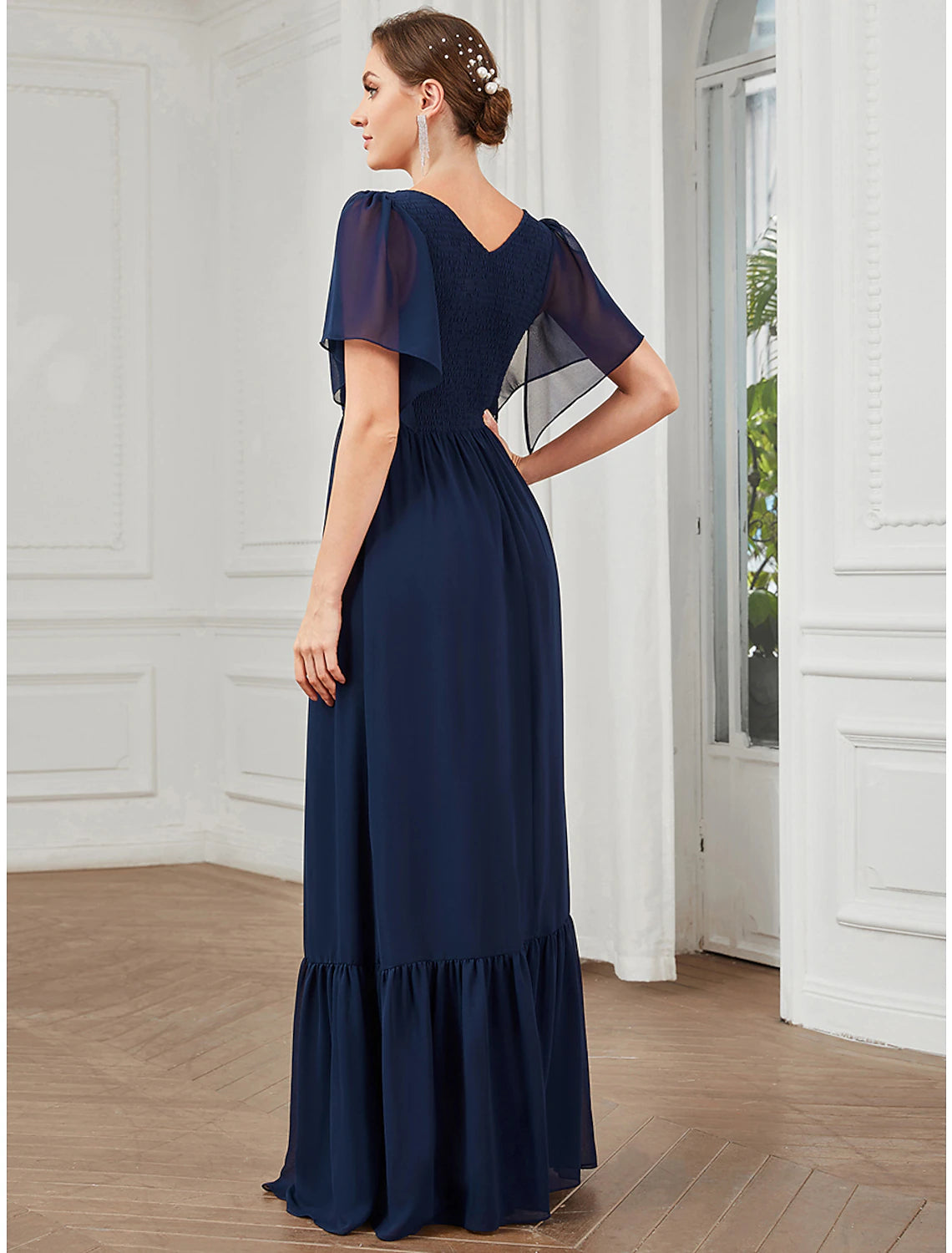 Full length view of a model in a light blue A-Line V-Neck short sleeve pleated chiffon dress.