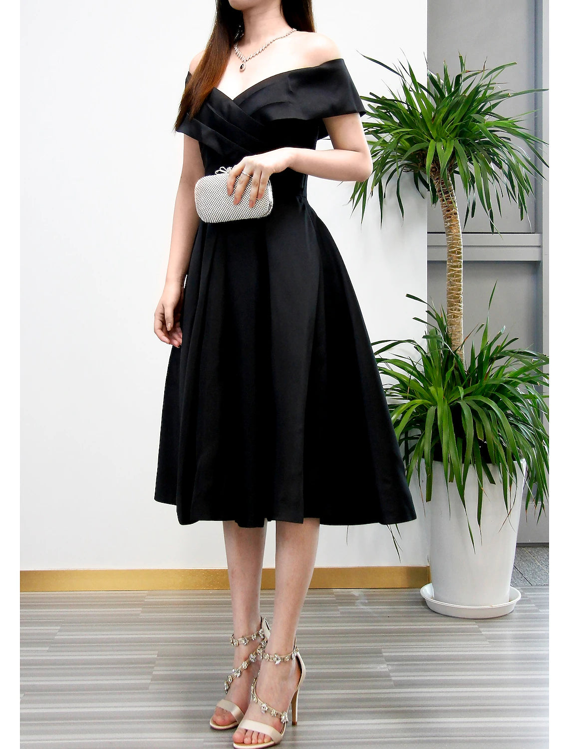 Woman modeling the back view of the A-Line V-neck tea length cocktail dress.
