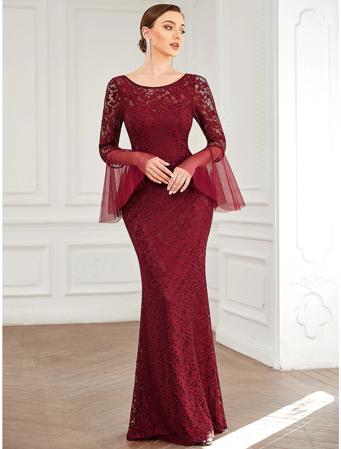 Mermaid trumpet gown with long lace sleeves, side profile.