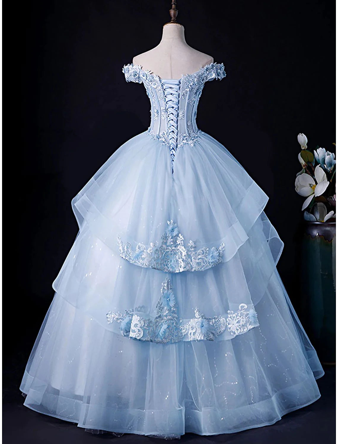 Back view of the elegant off-shoulder ball gown, showcasing the tulle and pleated details.