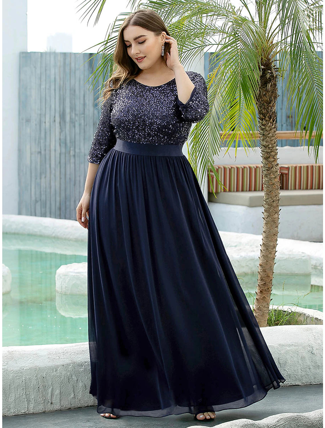 Model wearing an elegant plus size A-line jewel neck sequined tulle gown.