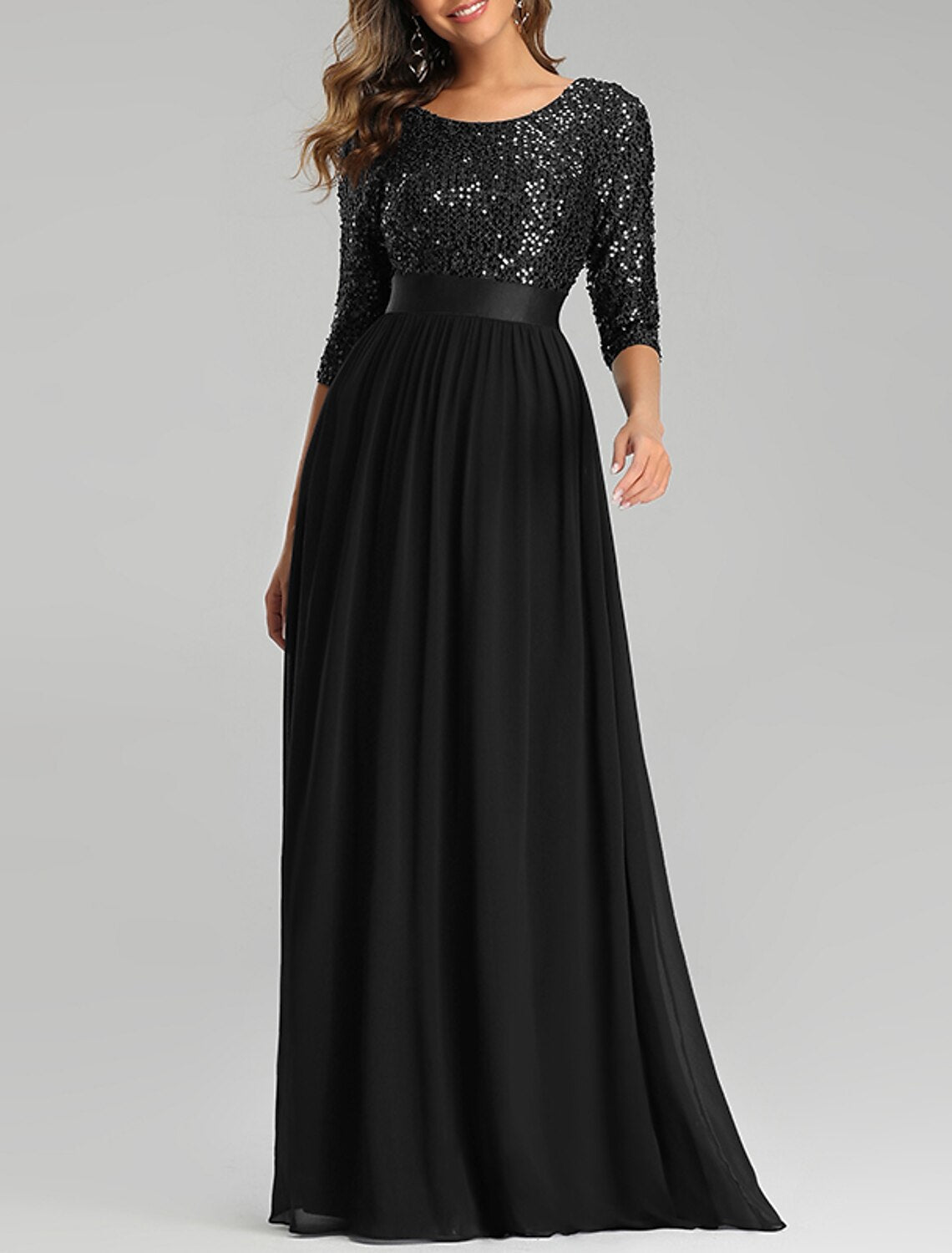Close-up of sequined tulle fabric and jewel neck on the elegant plus size gown.