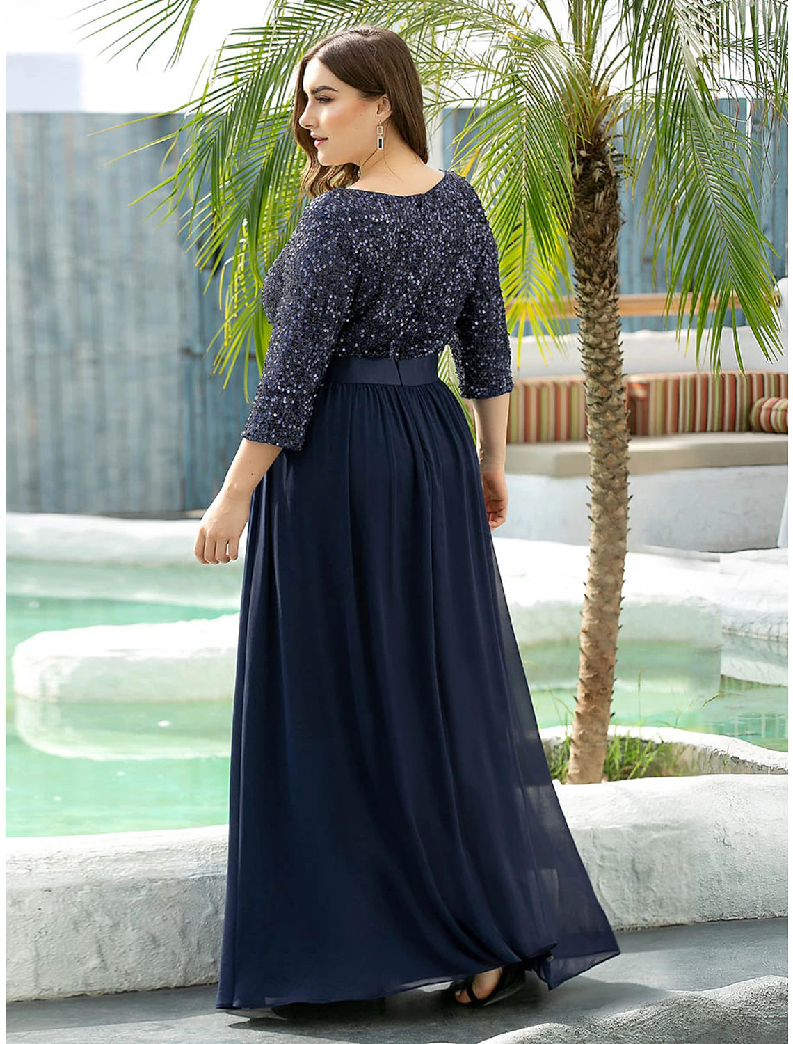 Side view of the elegant plus size A-line jewel neck sequined tulle gown.