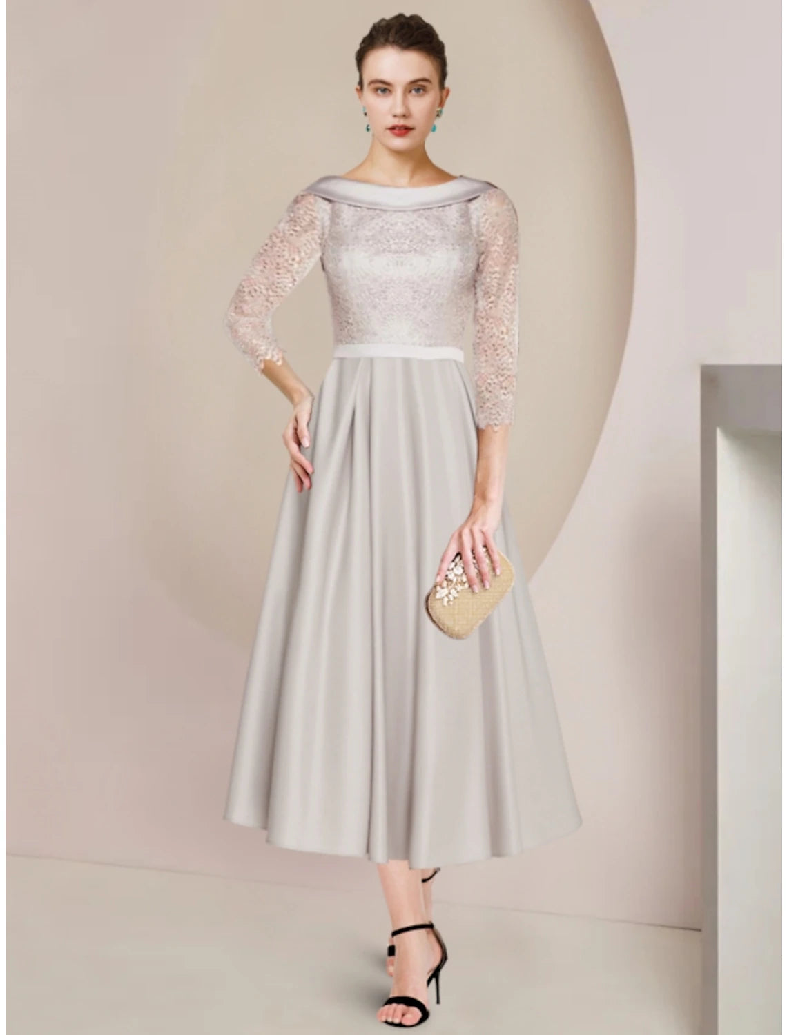 Elegant sheath tea-length dress with scoop neck and ruched half sleeves.