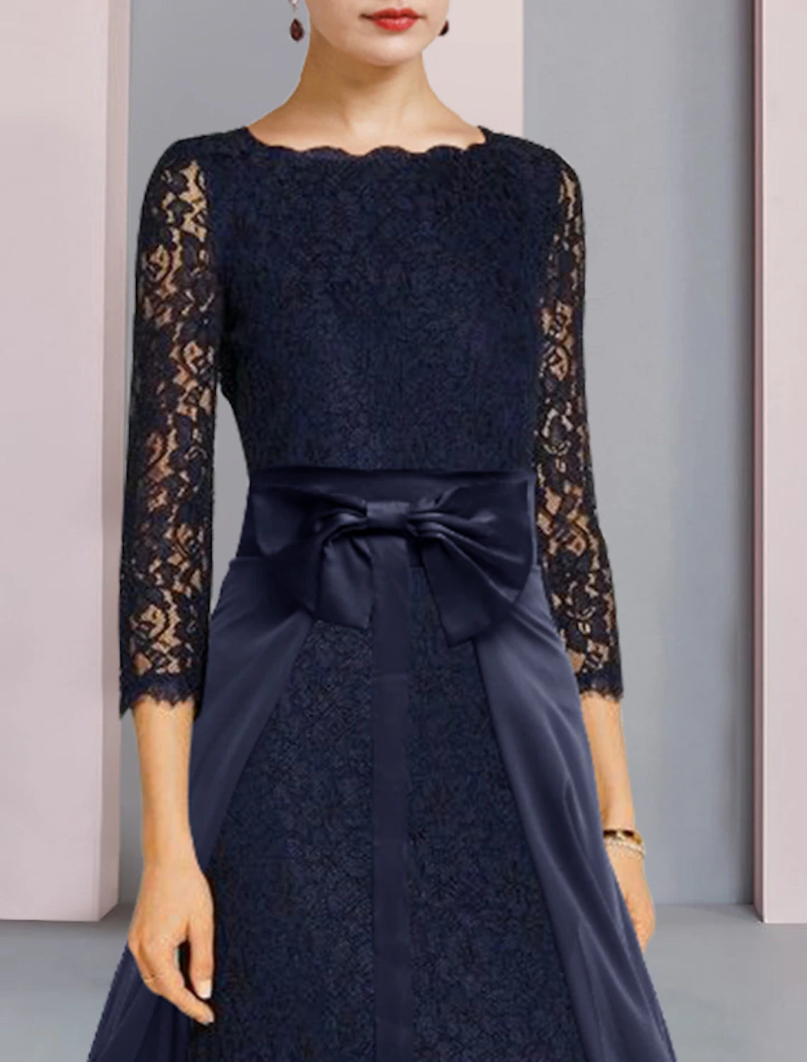 Close-up of lace and chiffon on two-piece wedding guest dress.