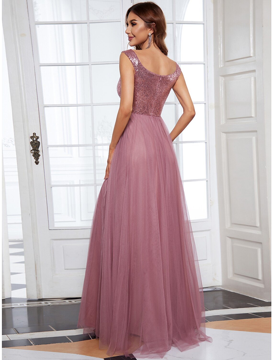 Full-length view of a woman modeling a solid color bridesmaid dress.