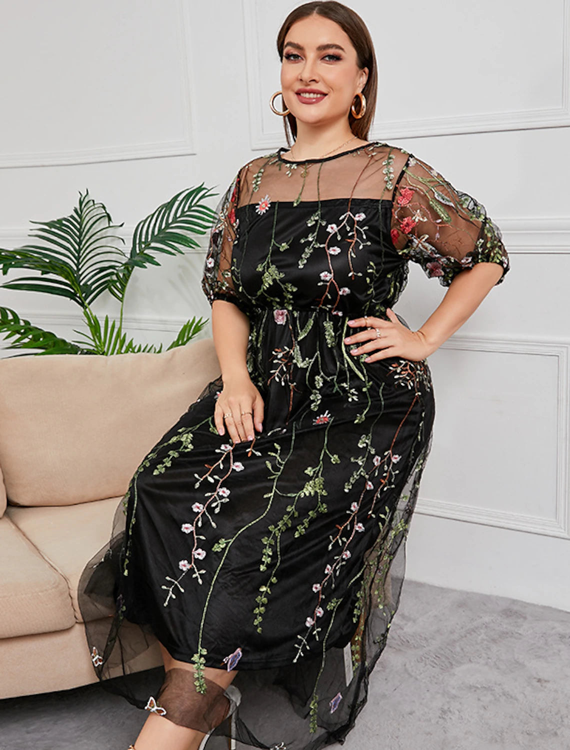 Side profile of the flattering plus size half sleeve embroidered formal dress.