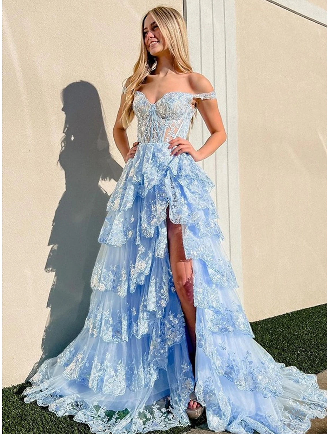 Back view of an off-shoulder mermaid trumpet gown with elegant train.