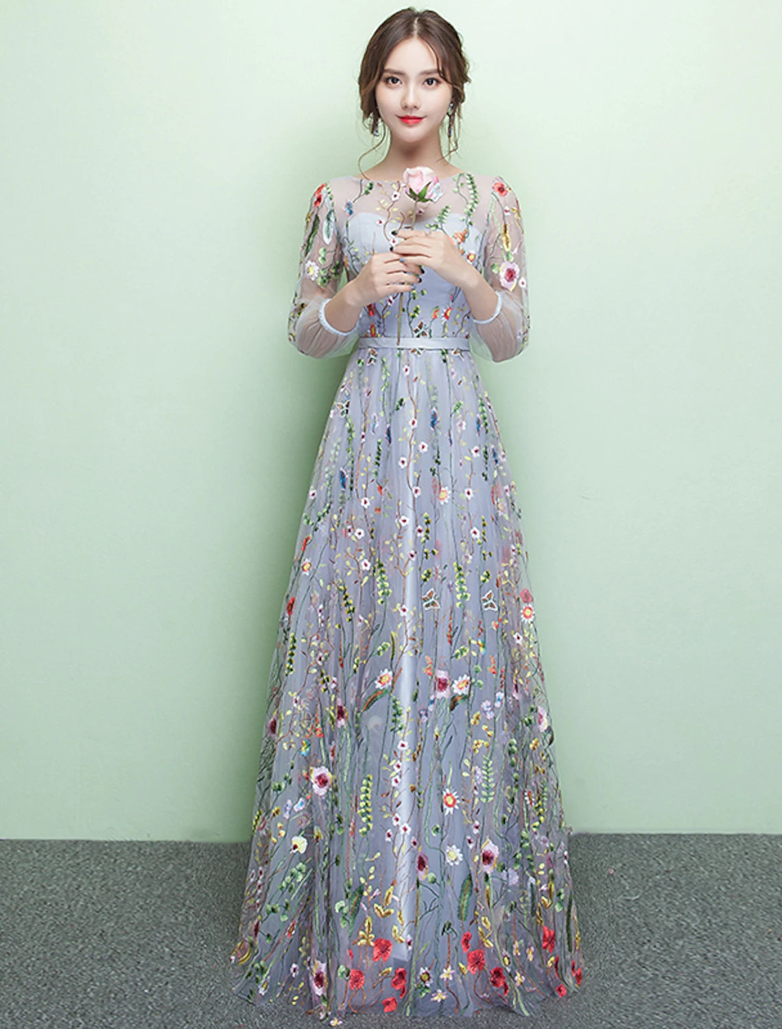 Model wearing a sparkling A-Line formal evening gown with jewel neck and 3/4 lace sleeves.