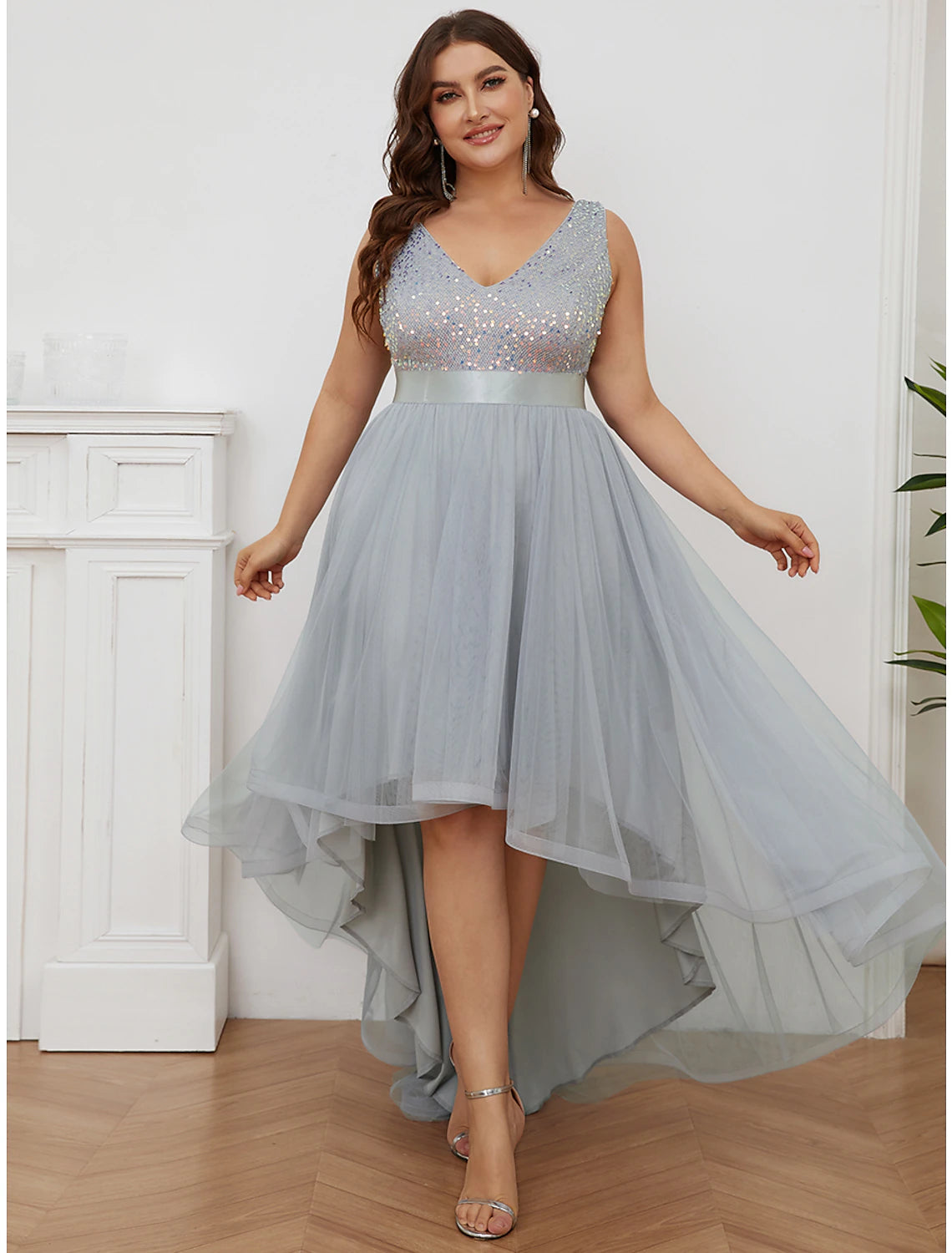 Front view of a sparkling A-line V-neck sequin tiered champagne maxi bridesmaid gown.