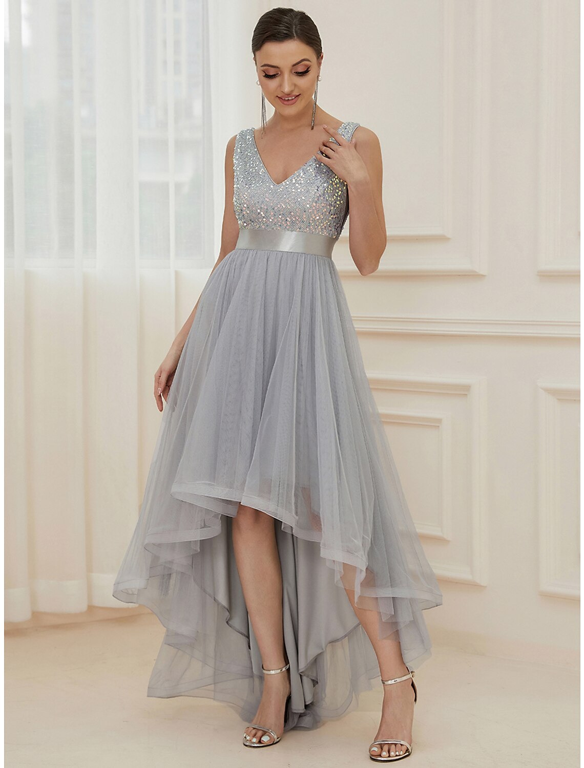 Back view of a sparkling A-line V-neck sequin tiered champagne maxi bridesmaid gown.